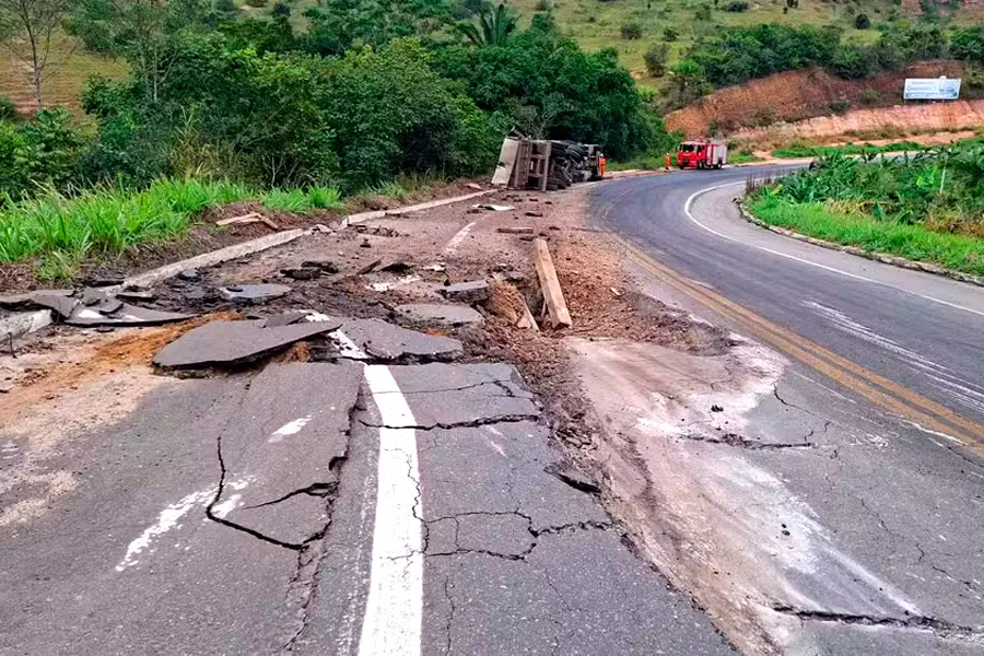 Caminhão carregado de pedras tomba e provoca rachaduras em asfalto 